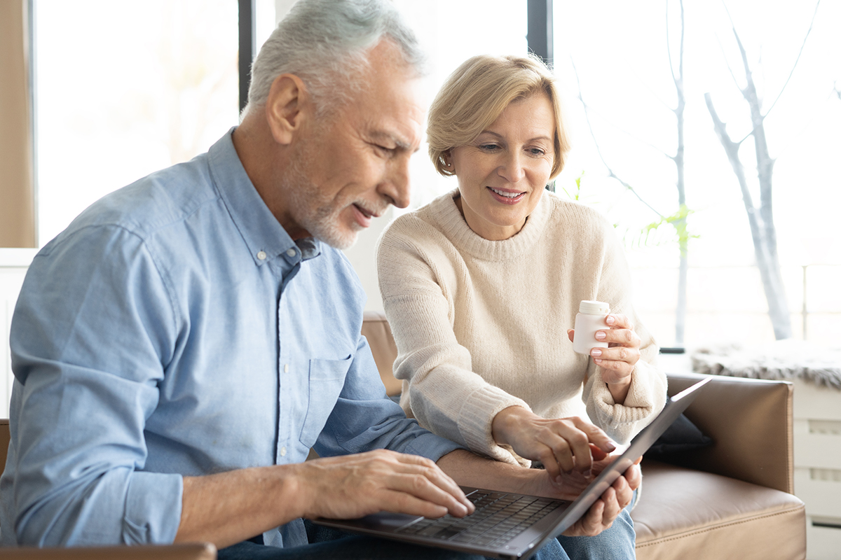 A senior couple working together on a laptop