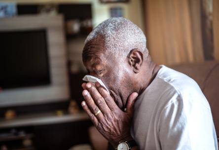 A man blowing his nose.