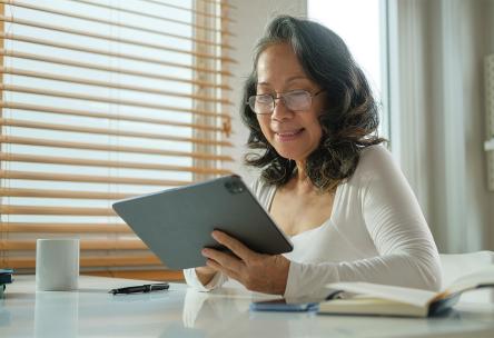 A senior uses a tablet