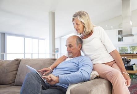 An older couple looks at a tablet screen