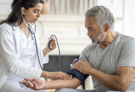 Man at doctor visit getting blood pressure taken