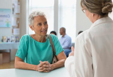 Woman talking to doctor.