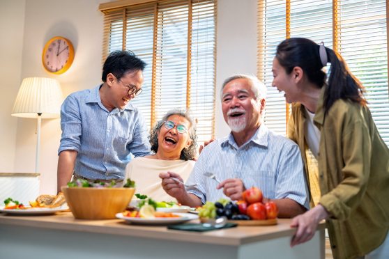 family laughing in kitchen 