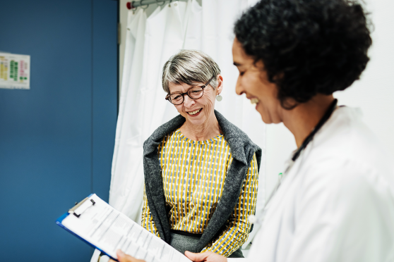 An gray-haired woman talks with her doctor