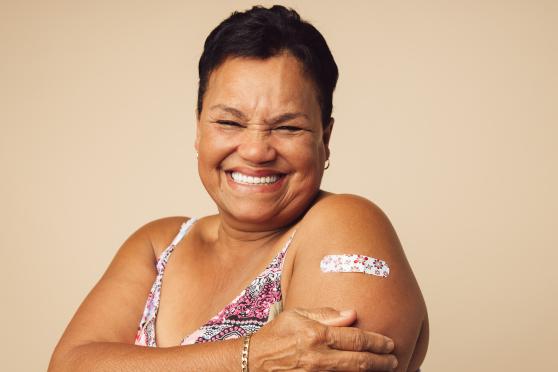 A woman with a bandage on her arm