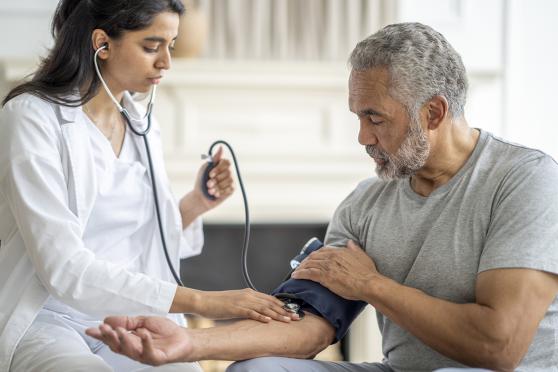 Man at doctor visit getting blood pressure taken