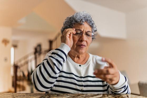 A woman looking at a prescription.